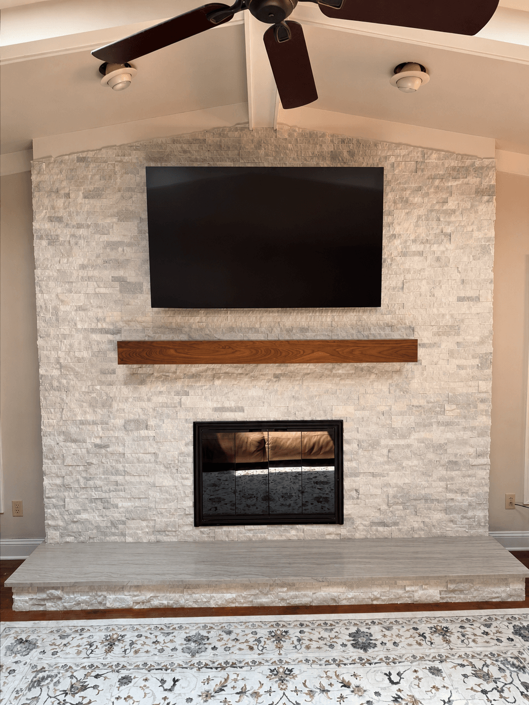 Cleaned portfolio view of stone fireplace and wood mantel completed by DHR